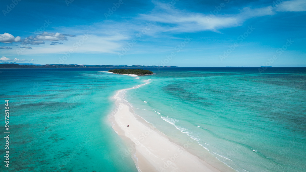 Obraz premium Aerial view of Nosy Iranja Island showcasing pristine waters and sandy beach pathway in Madagascar during daylight