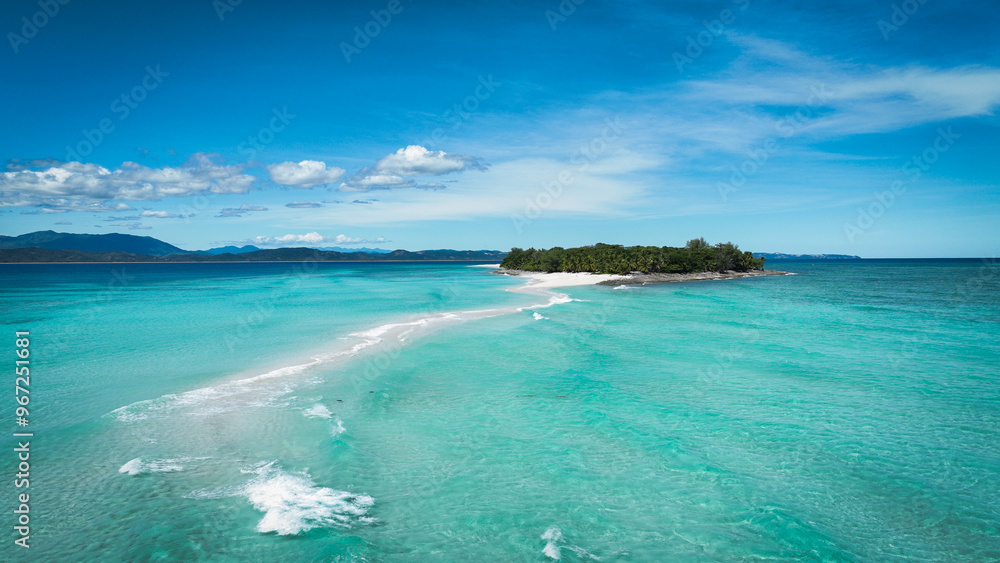 Aerial view of Nosy Iranja Island showcasing turquoise waters and sandy beach at midday in Madagascar Aerial view of Nosy Iranja Island showcasing turquoise waters and sandy beach at midday in Madagascar
