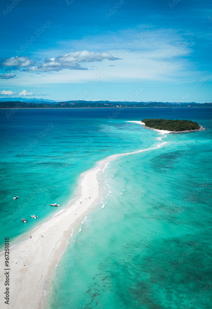 Aerial view of Nosy Iranja Island showcasing its pristine beach and turquoise waters in Madagascar under clear skies Aerial view of Nosy Iranja Island showcasing its pristine beach and turquoise waters in Madagascar under clear skies
