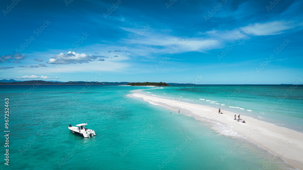 Aerial view of Nosy Iranja Island in Madagascar showcasing sandy beach and clear turquoise waters on a sunny day Aerial view of Nosy Iranja Island in Madagascar showcasing sandy beach and clear turquoise waters on a sunny day