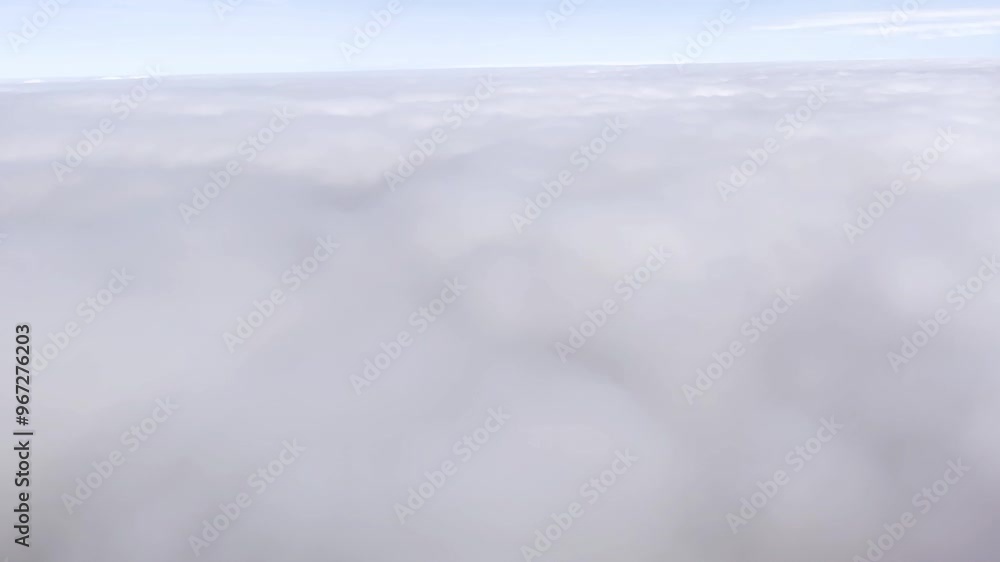 Layer of fluffy white clouds captured from an airplane, as it's descending into them. Layer of fluffy white clouds captured from an airplane, as it's descending into them.