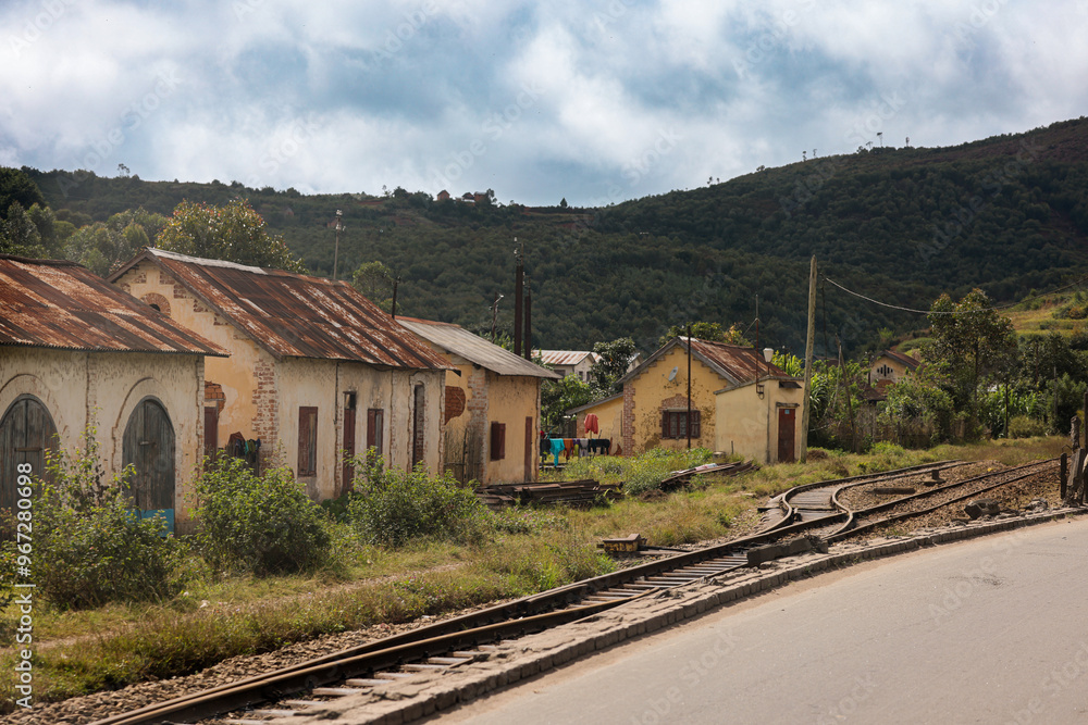 Rustic buildings along the railway in a suburb of Antananarivo, Madagascar, showcasing daily life and the surrounding landscape Rustic buildings along the railway in a suburb of Antananarivo, Madagascar, showcasing daily life and the surrounding landscape