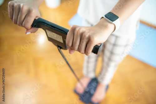 Woman weighing herself on a body fat scale.