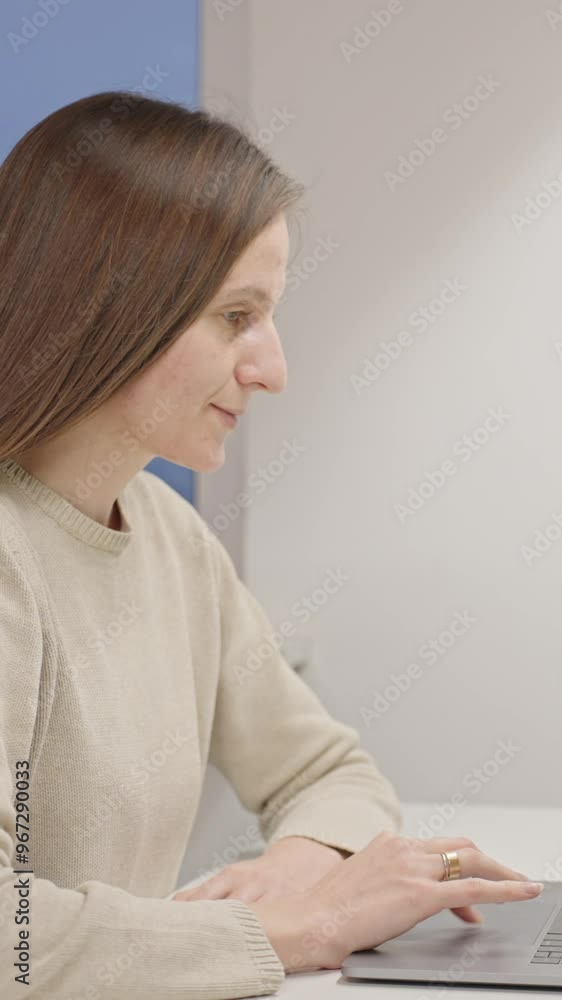 Close-up focused positive young female student typing on laptop in modern apartment. Preparing for exams, working on a new project, using AI tools to create presentation, researching, self-development Close-up focused positive young female student typing on laptop in modern apartment. Preparing for exams, working on a new project, using AI tools to create presentation, researching, self-development