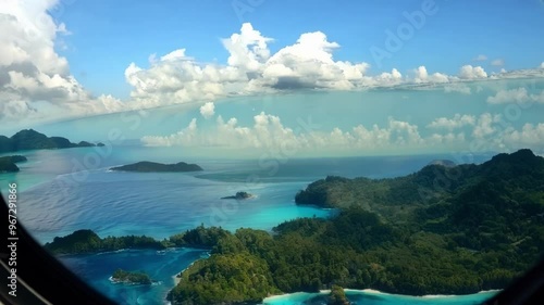 Wallpaper Mural Gazing out the window of a private jet, you'll see lush green tropical islands surrounded by turquoise blue water, capturing the essence of luxury travel and vacationing in paradise Torontodigital.ca