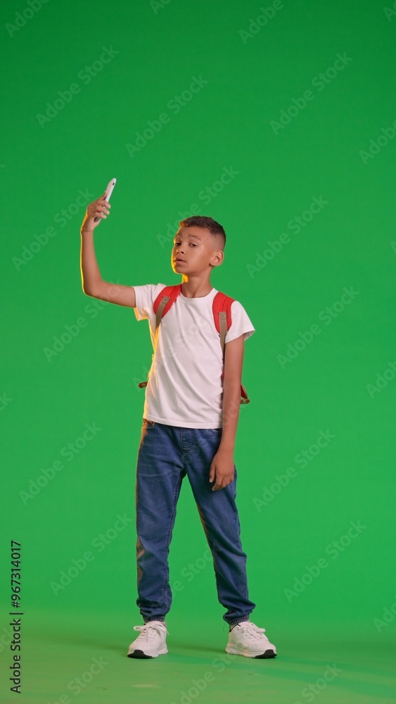 Schoolboy Taking Selfie with Smartphone on Green Screen Schoolboy Taking Selfie with Smartphone on Green Screen