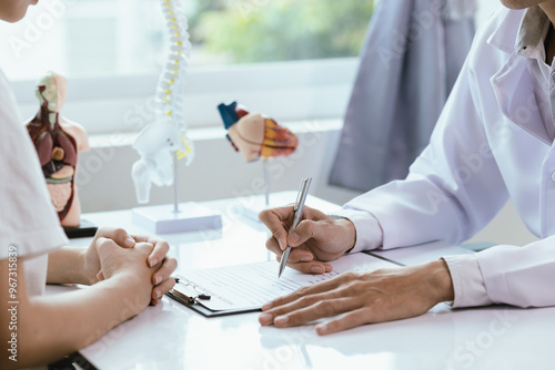 Photos Asian male doctor consults with patient in clinic, reviews medical documents and uses stethoscope to diagnose health conditions, and confidently provides professional advice and care