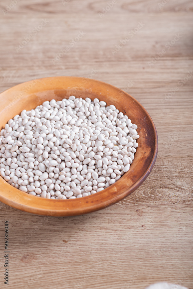White beans on wooden table in kitchen White beans on wooden table in kitchen