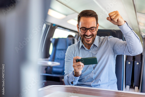 Excited Businessman Celebrating Success While Traveling on Train