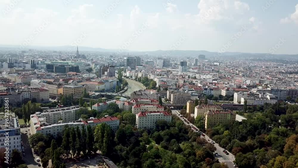 Aerial approaching flight of first district in Vienna, Austria with historic apartment buildings. Sunny day with clouds in the air. Driving cars in road. Expensive housing area. Wide Aerial approaching flight of first district in Vienna, Austria with historic apartment buildings. Sunny day with clouds in the air. Driving cars in road. Expensive housing area. Wide