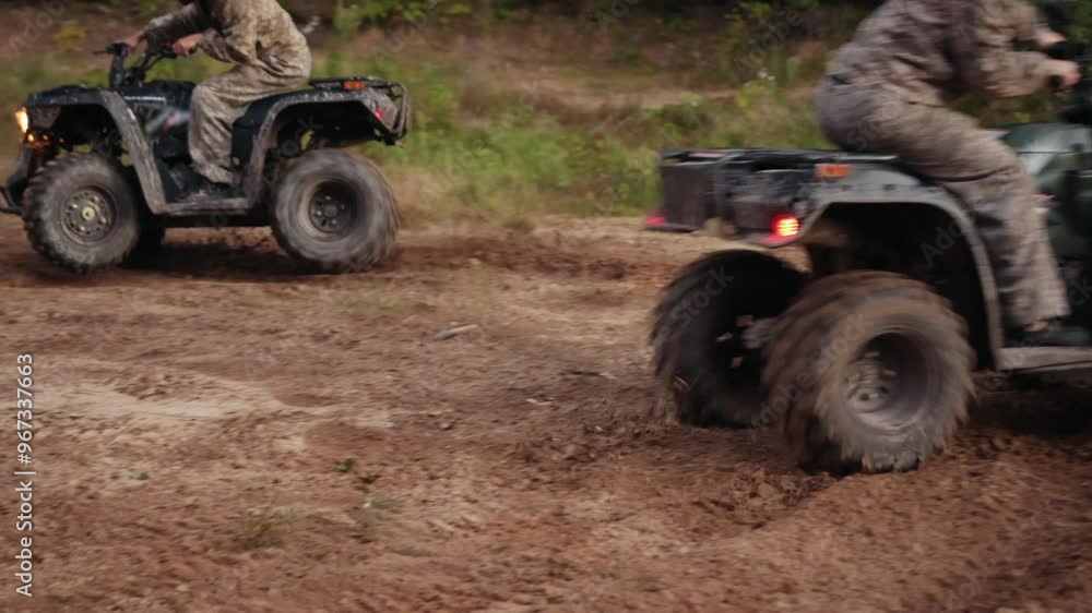 rough trail, rugged outdoors, off-road trail. Riders in camouflage gear race ATVs through rough dirt trail, sending dust flying as they tackle rugged terrain. rough trail, rugged outdoors, off-road trail. Riders in camouflage gear race ATVs through rough dirt trail, sending dust flying as they tackle rugged terrain.