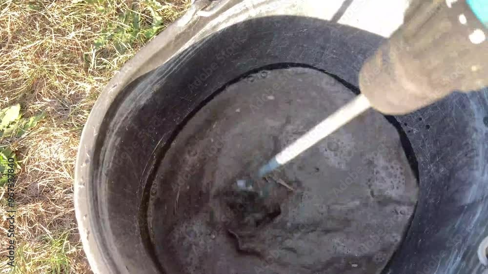 The process of mixing cement and sand for concreti The process of mixing cement and sand for concreti