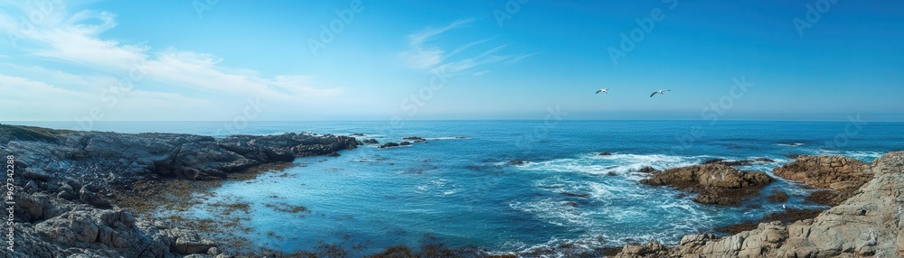 Soft breeze moving across a rocky coastline, waves lapping gently against the shore, distant seagulls soaring, a calm and refreshing ocean scene Soft breeze moving across a rocky coastline, waves lapping gently against the shore, distant seagulls soaring, a calm and refreshing ocean scene