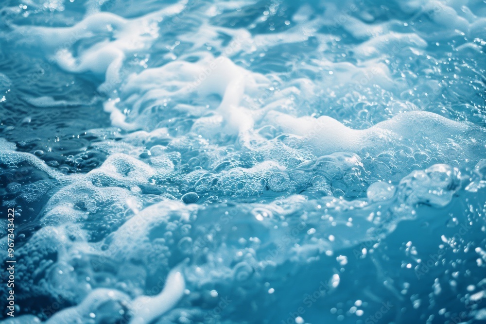 Close-up of gentle ocean waves, featuring a soothing and calm display of water and foam under the light. Close-up of gentle ocean waves, featuring a soothing and calm display of water and foam under the light.