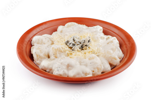 Gnocchi topped with blue cheese and parmesan are served on a plate