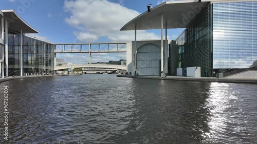 Government District Berlin, Germany, Juli 25, 2024,  time lapse view to Paul-Löbe-Haus and the Spree river with ship traffic on a sunny day, loop able