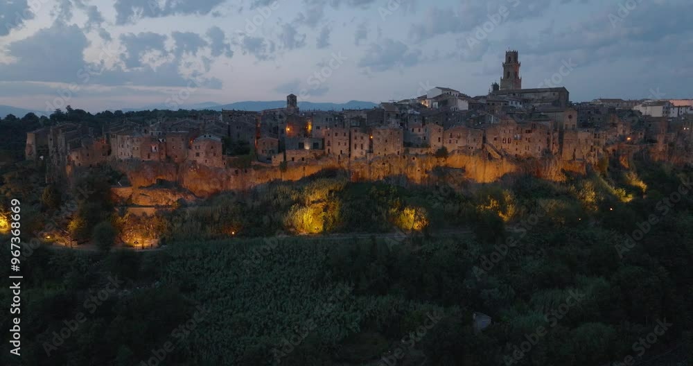 Aerial Drone view of the hilltop Medieval town of Pitigliano, Tuscany at dusk, with blinking lights and twilight sky, in 4K Aerial Drone view of the hilltop Medieval town of Pitigliano, Tuscany at dusk, with blinking lights and twilight sky, in 4K