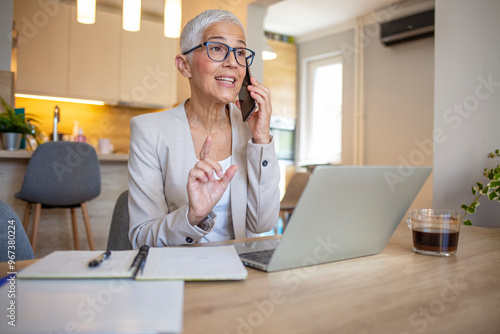 Senior Businesswoman Engaged in a Phone Call at Home Office