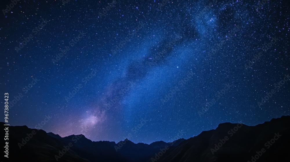 A clear night sky filled with vibrant stars and a visible Milky Way, with a silhouette of mountains below. A clear night sky filled with vibrant stars and a visible Milky Way, with a silhouette of mountains below.