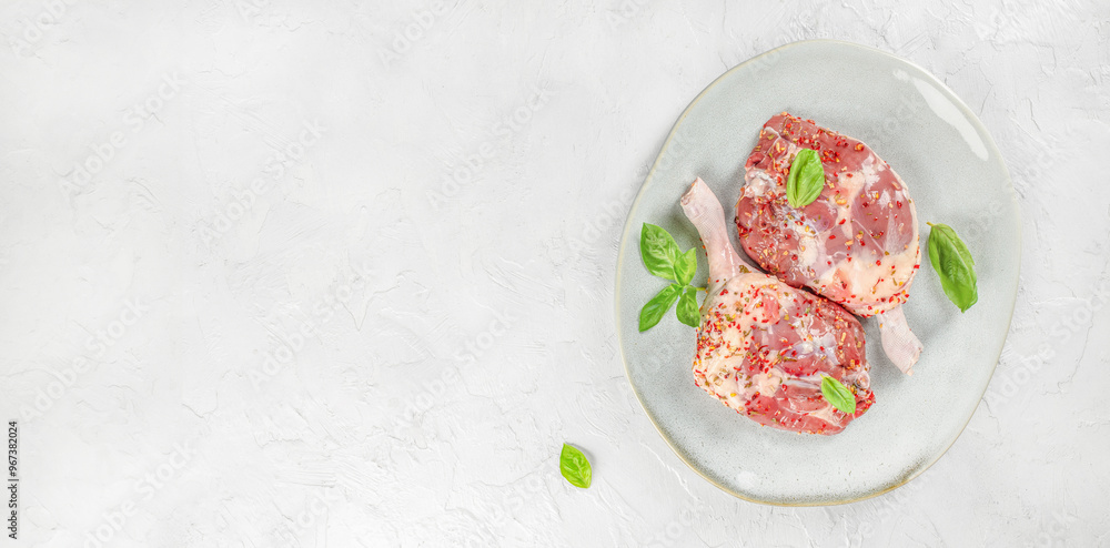 Raw Duck Legs with herbs on a light background top view. copy space Raw Duck Legs with herbs on a light background top view. copy space