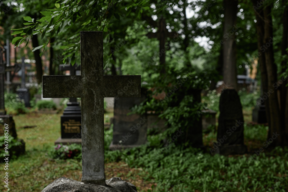 Background shot of concrete cross shaped tombstone covered with dirt and moss serving as lasting memorial to passed away standing in gloomy cemetery, copy space Background shot of concrete cross shaped tombstone covered with dirt and moss serving as lasting memorial to passed away standing in gloomy cemetery, copy space