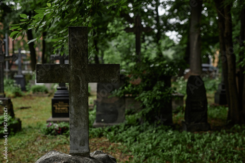 Background shot of concrete cross shaped tombstone covered with dirt and moss serving as lasting memorial to passed away standing in gloomy cemetery, copy space