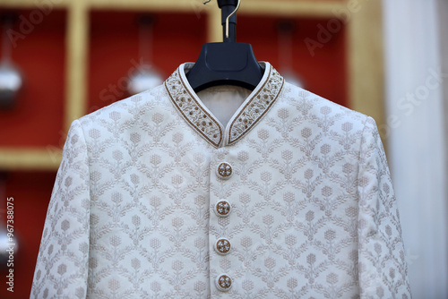 A close-up of intricate floral embroidery on a rich fabric, intricate embroidery and pearls. The detailed craftsmanship showcases traditional Indian design elements, adding elegance. photo