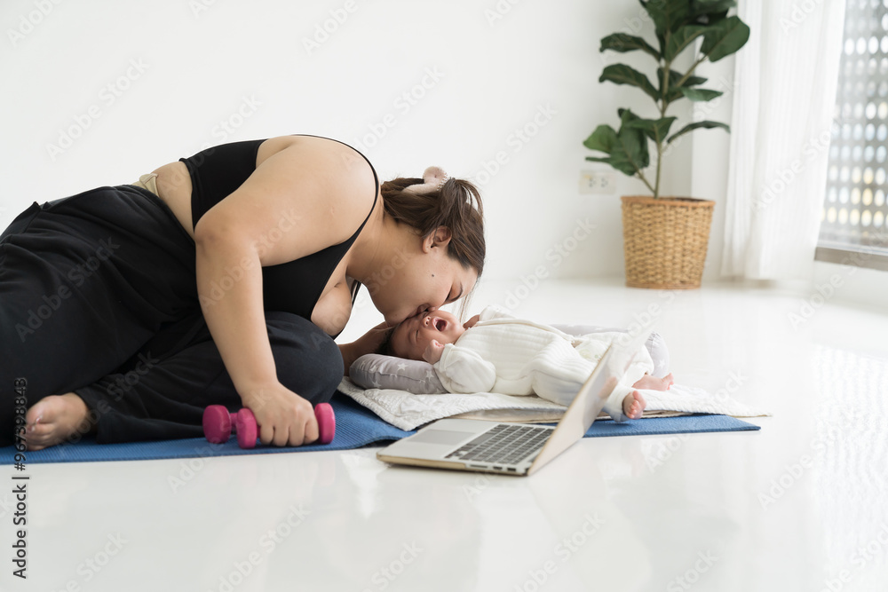 Obraz premium Asian plus size mother doing exercises on yoga mat and taking care her newborn at home