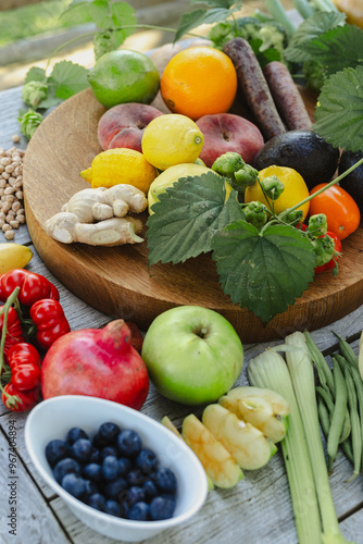 fresh fruits and vegetables on a table outside in the garden