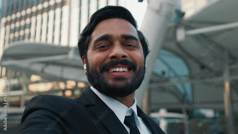 First person view of boss making hello gesture at start of video conference with team of coworkers. Laughing male connecting with colleagues in office while standing outside of business centre. First person view of boss making hello gesture at start of video conference with team of coworkers. Laughing male connecting with colleagues in office while standing outside of business centre.