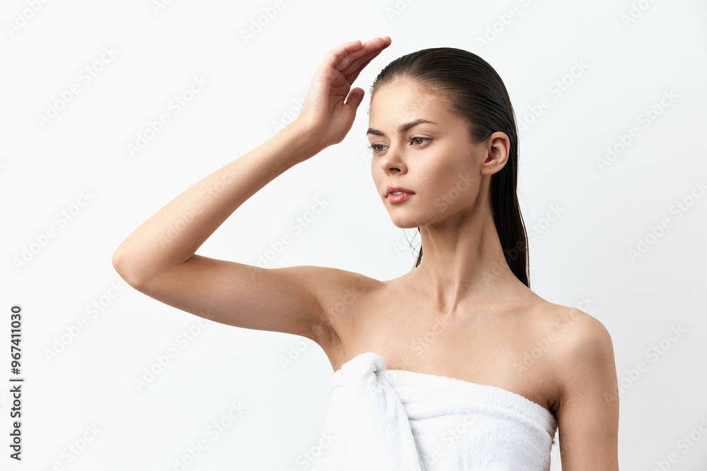 Beautiful young woman with wet hair posing thoughtfully against a clean white background, conveying elegance and tranquility in a serene atmosphere, perfect for beauty or lifestyle themes Beautiful young woman with wet hair posing thoughtfully against a clean white background, conveying elegance and tranquility in a serene atmosphere, perfect for beauty or lifestyle themes