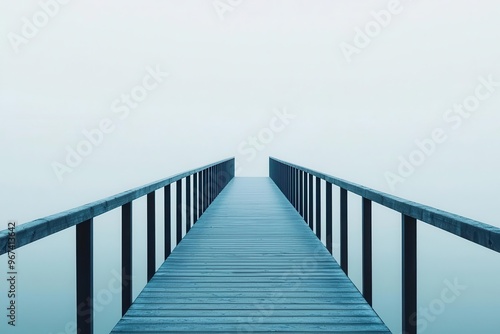 A serene wooden pier extends over calm waters, enveloped in soft mist, creating a tranquil and peaceful atmosphere.