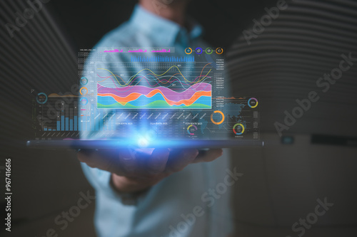 Devops digital tech data analysis financail and technology Businessman using digital tablet with data charts blurred tech background photo