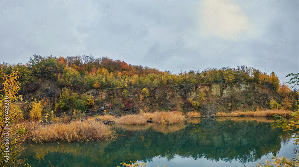 Autumn landscape with a lake at the site of an old quarry. Dreary atmosphere of late fall Autumn landscape with a lake at the site of an old quarry. Dreary atmosphere of late fall