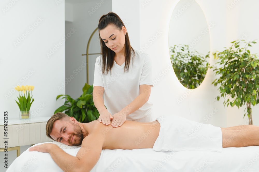 Young man is enjoying massage on spa treatment Young man is enjoying massage on spa treatment