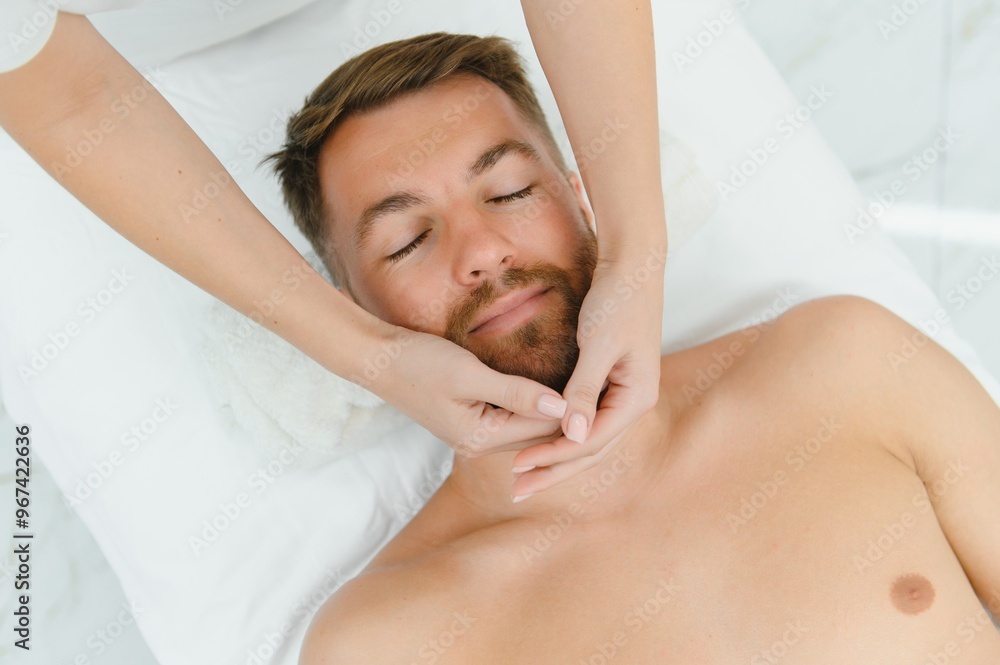Spa therapist making relaxing massage for handsome man. Male cosmetology concept Spa therapist making relaxing massage for handsome man. Male cosmetology concept
