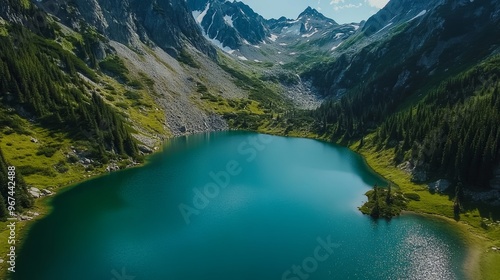 Fototapeta Naklejka Na Ścianę i Meble -  Aerial view of a pristine alpine lake, surrounded by rugged mountain peaks and dense pine forests.