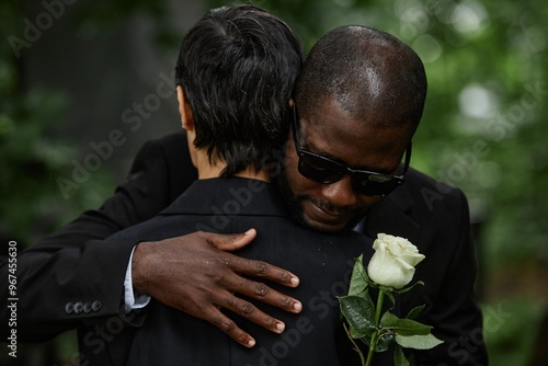 Fotografía Medium shot of adult Black man in sunglasses hugging senior woman while grieving