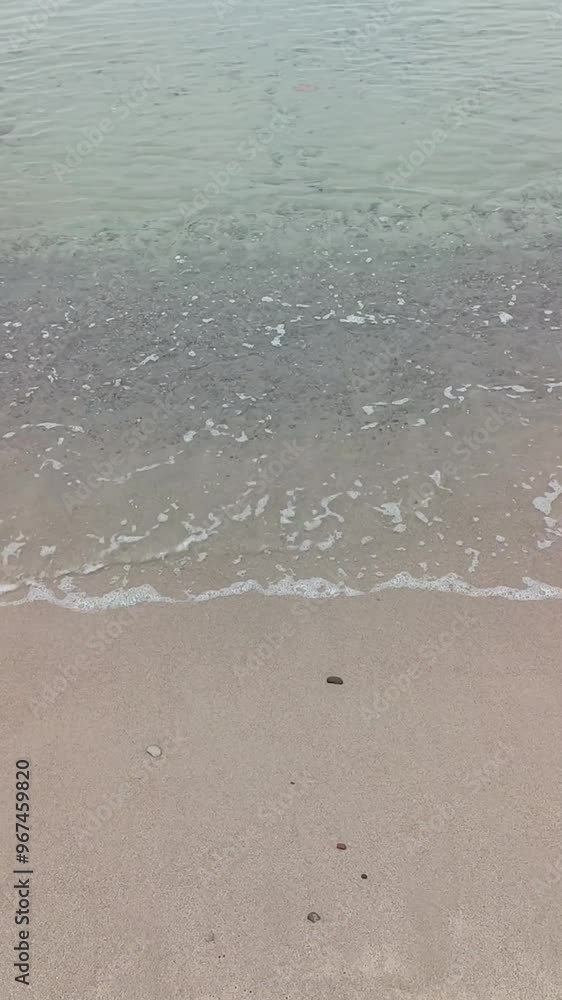 Clear waves and white sand in cloudy weather Clear waves and white sand in cloudy weather