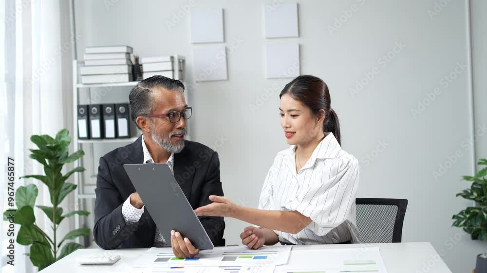 Business team reviewing documents and discussing strategy Business team reviewing documents and discussing strategy