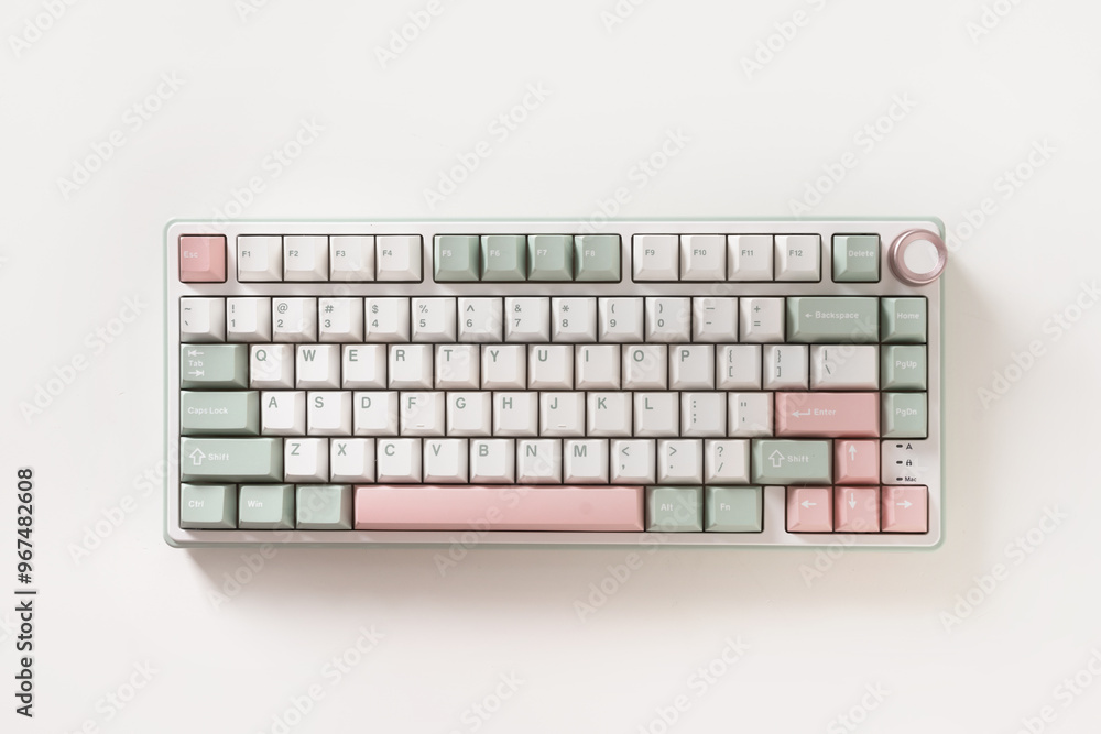 Modern mechanical keyboard on white background. Minimal style and design keyboard. Custom build keyboard. Colorful key pastel creamy pink and green cap. Top view.