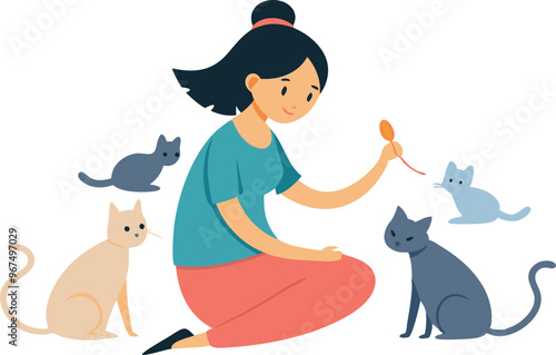 A woman is sitting on the floor with her cats. She is feeding them with a toy. The cats are of different colors and sizes