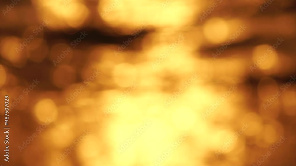 Blurred golden sea at sunset. The sun reflects and sparkles on the waves with bokeh, illuminating the golden sea. Holiday recreation concept. Abstract nautical summer ocean sunset nature background. Blurred golden sea at sunset. The sun reflects and sparkles on the waves with bokeh, illuminating the golden sea. Holiday recreation concept. Abstract nautical summer ocean sunset nature background.