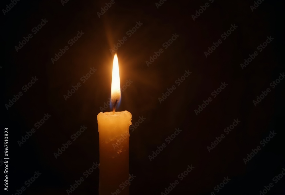 Single lit candle against a dark background creating a serene atmosphere. Single lit candle against a dark background creating a serene atmosphere.