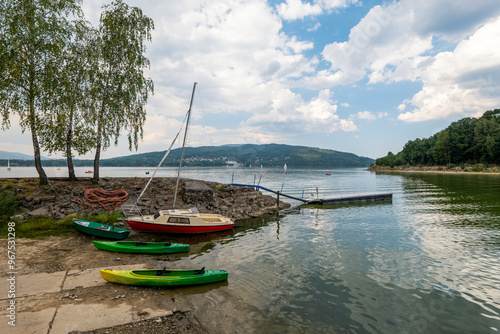 A beautiful lake among the mountains. Boat and kayaks at the coast. Żywieckie Lake, Żywiec, Poland