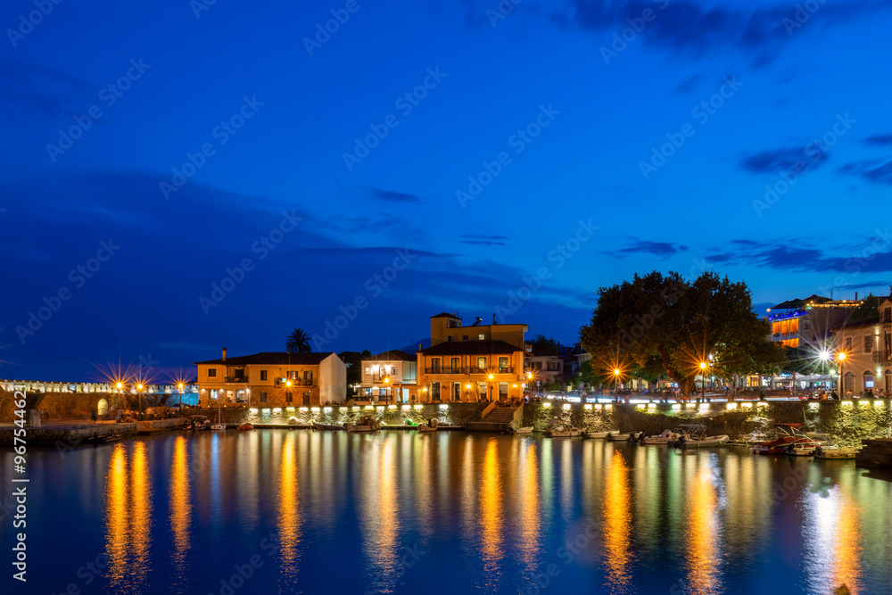 Nafpaktos port blue hour. A beautiful touristic destination with the town lights reflecting water.
