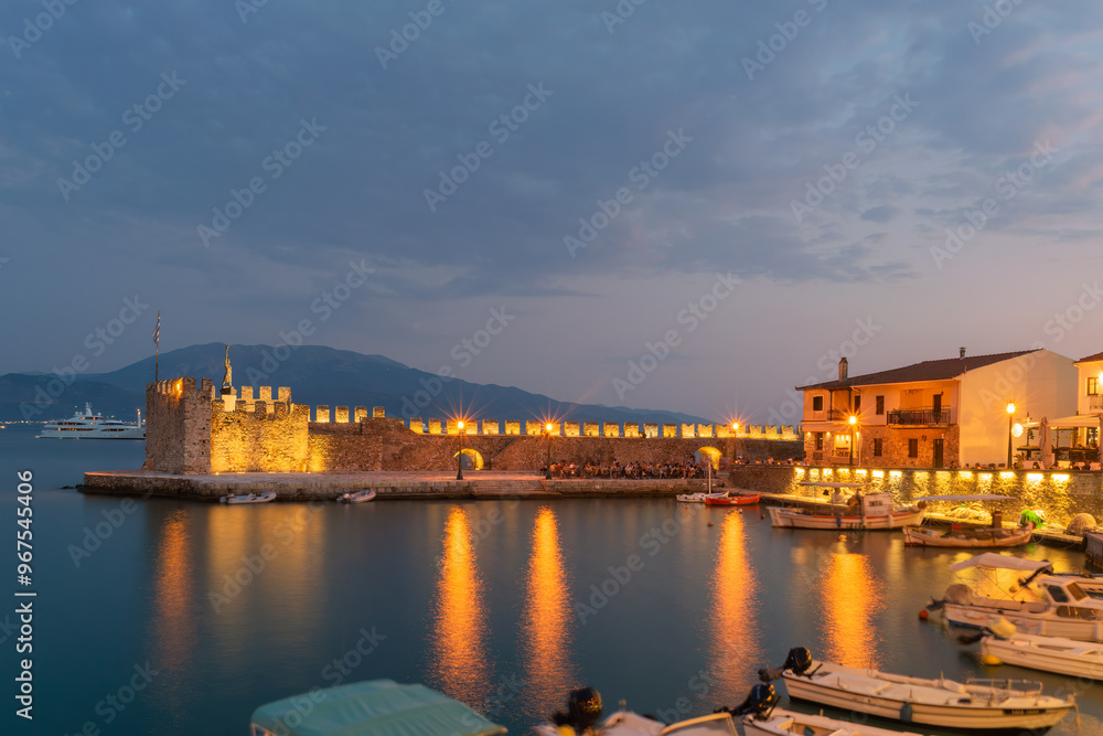 Nafpaktos port in Greece against the city lights.