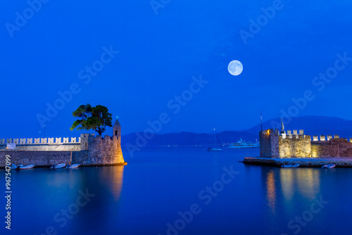 Obraz na płótnie Blue hour in Nafpaktos port in Greece against the full moon.
w salonie