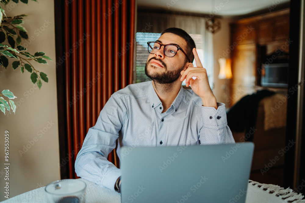 Young caucasian businessman working from home on laptop Young caucasian businessman working from home on laptop