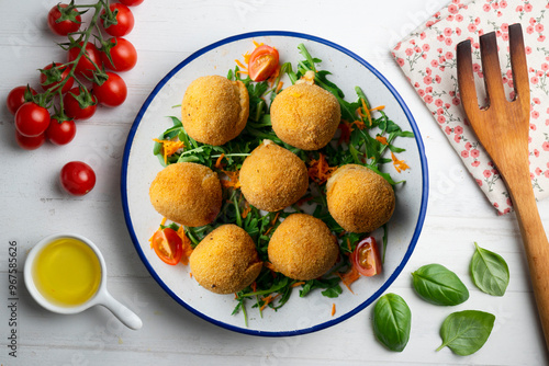 Spanish Tapa croquettes made with bechamel sauce and stuffed with iberian ham. Top view table with christmas decoration.